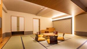 低い丸テーブルと座椅子のある畳の客室