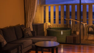 Private open-air bath beside sofa in guest room