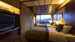 Two beds in a guest room with balcony view